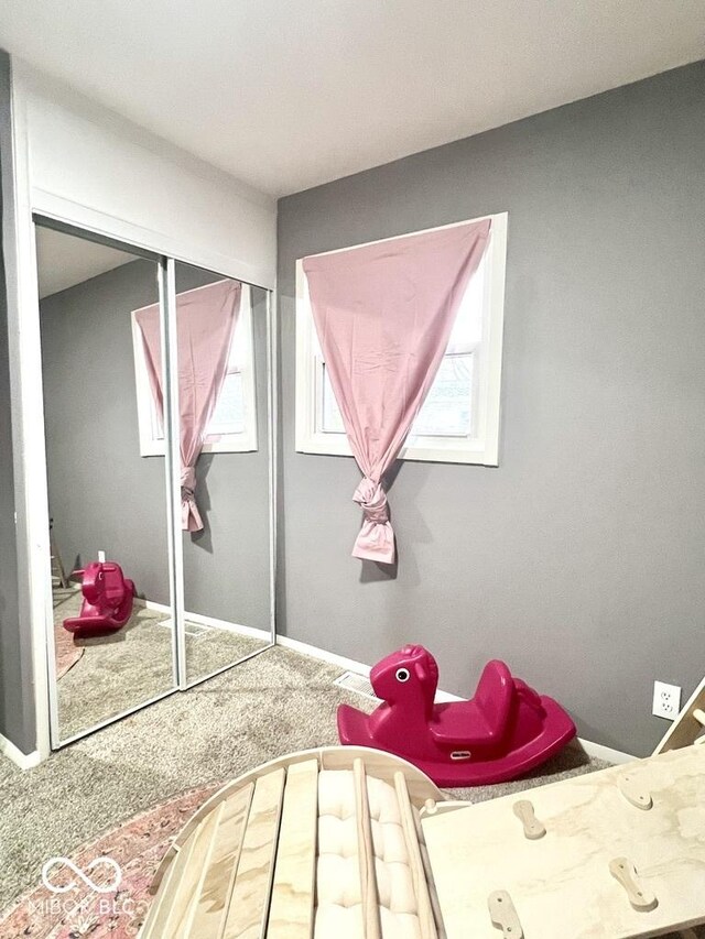 carpeted bedroom with a closet