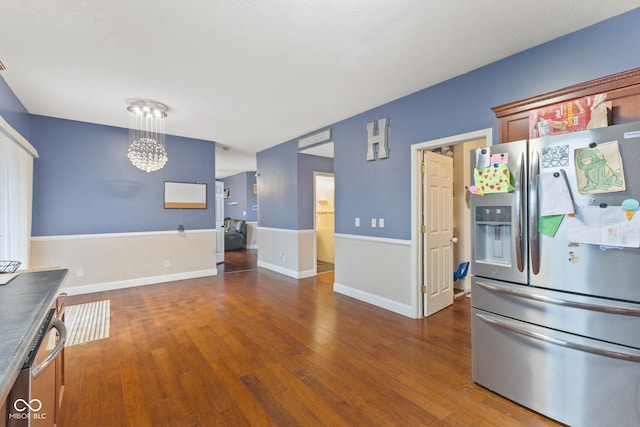 kitchen featuring pendant lighting, dark hardwood / wood-style floors, and stainless steel appliances