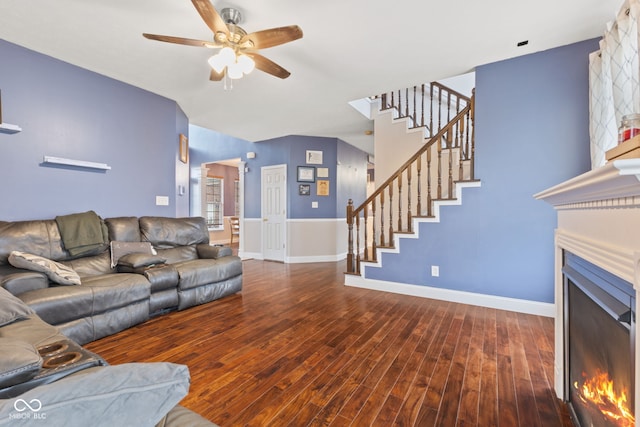 living room with dark hardwood / wood-style floors and ceiling fan