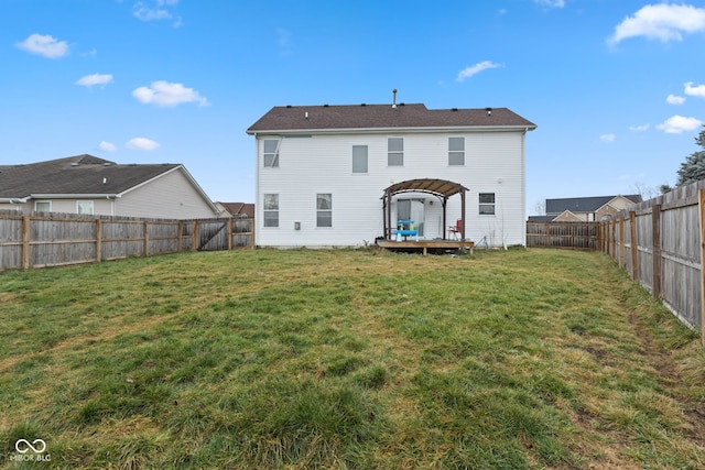 back of property with a pergola, a wooden deck, and a yard