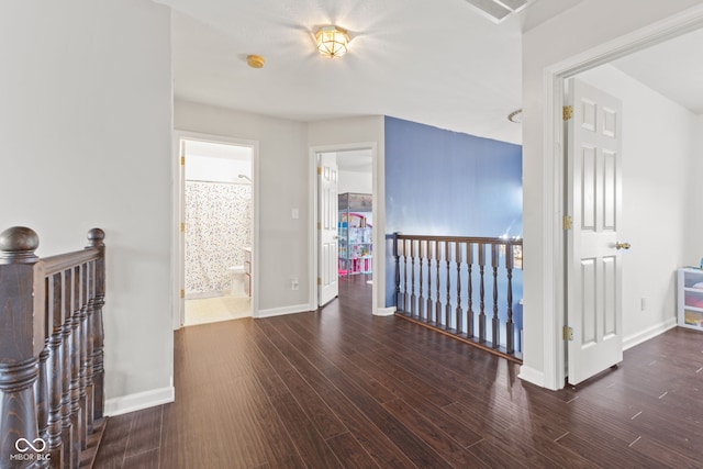 corridor with dark hardwood / wood-style flooring