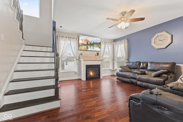 living room featuring ceiling fan and dark wood-type flooring