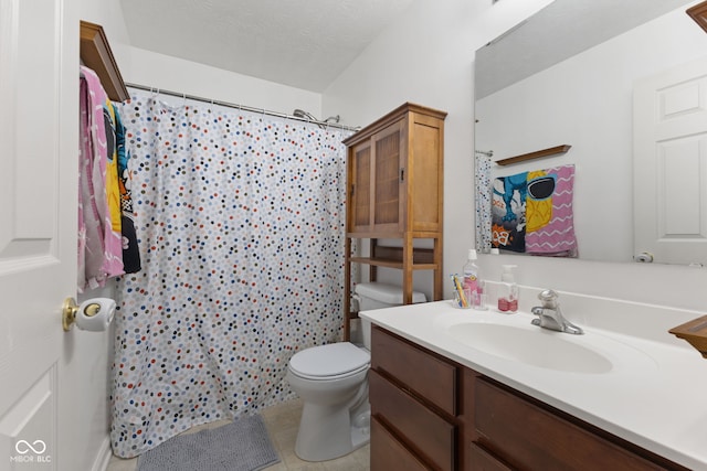 bathroom with walk in shower, a textured ceiling, vanity, tile patterned flooring, and toilet