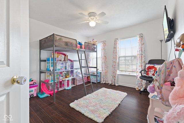 playroom with ceiling fan and dark hardwood / wood-style flooring