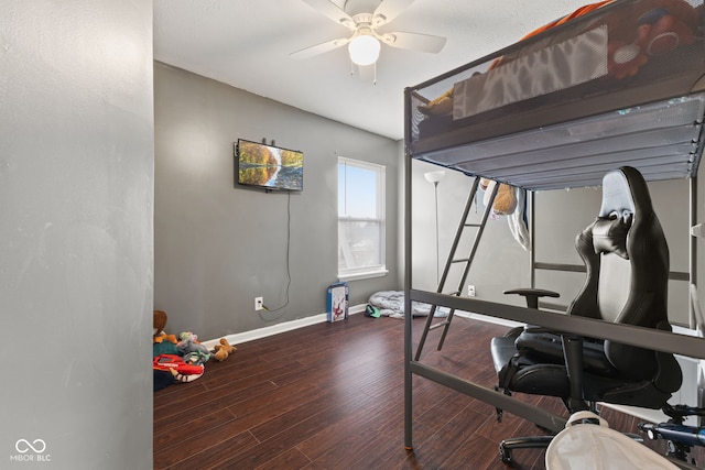 bedroom with ceiling fan and dark hardwood / wood-style flooring