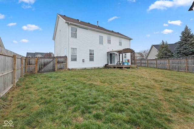 back of house featuring a pergola, a yard, and a deck