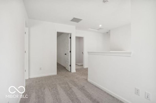 unfurnished room featuring light carpet