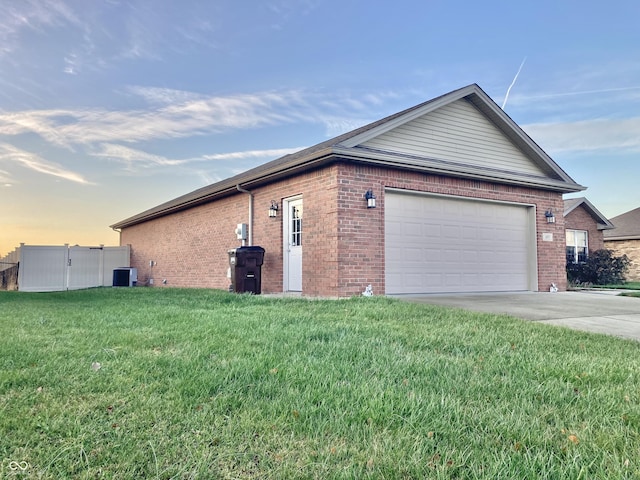 property exterior at dusk with a yard and central AC unit