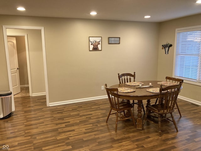 dining area with dark hardwood / wood-style flooring