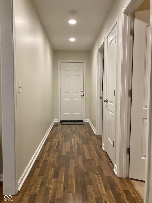 hallway with dark hardwood / wood-style floors