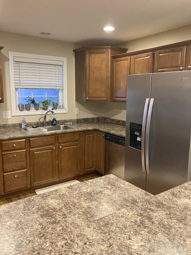 kitchen featuring stainless steel appliances, hardwood / wood-style flooring, and sink