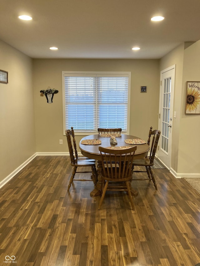 dining room with dark hardwood / wood-style flooring