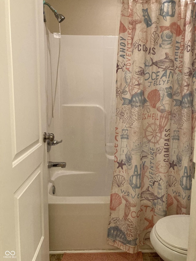 bathroom featuring shower / bathtub combination with curtain and toilet