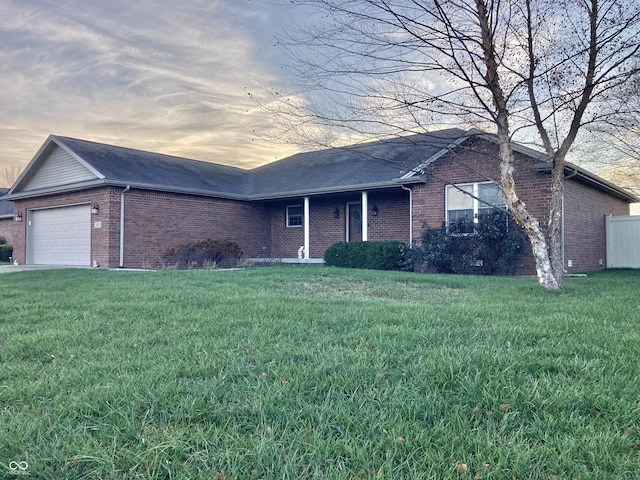 ranch-style home with a yard and a garage