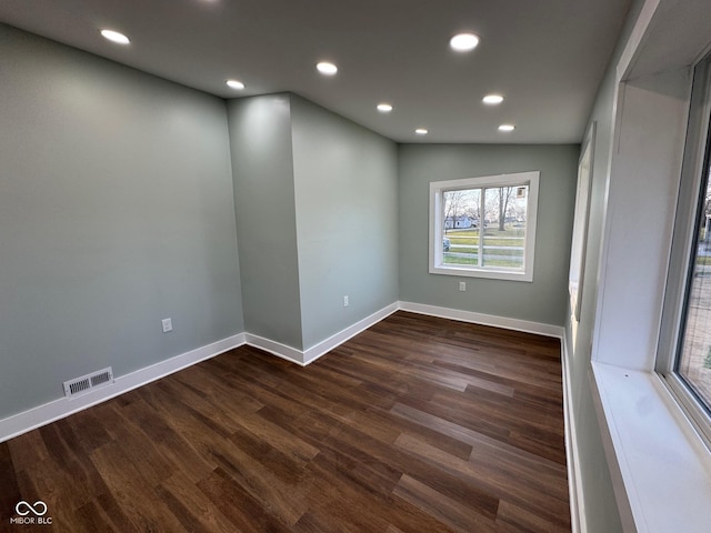 empty room featuring dark hardwood / wood-style floors and vaulted ceiling