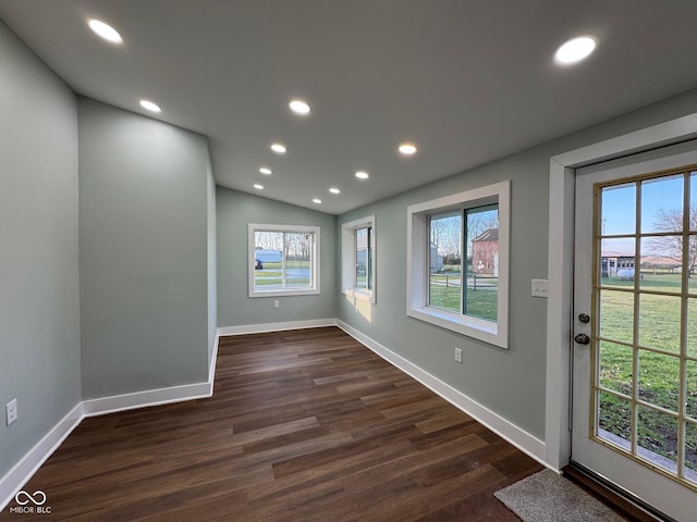 interior space featuring dark hardwood / wood-style flooring and lofted ceiling