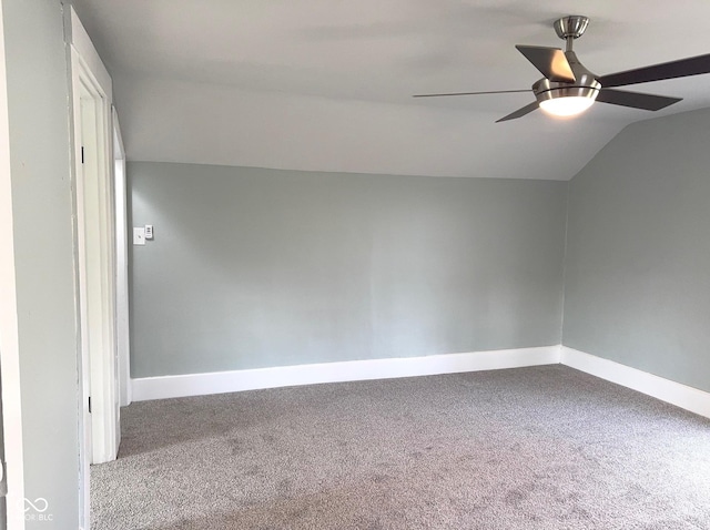 carpeted empty room with ceiling fan and vaulted ceiling