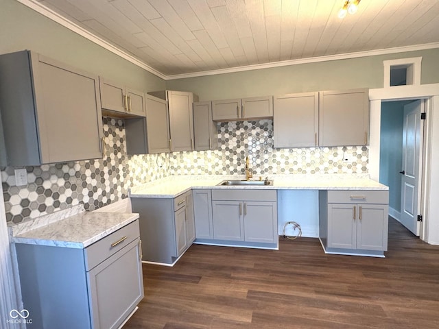 kitchen featuring ornamental molding, backsplash, dark wood-type flooring, and sink