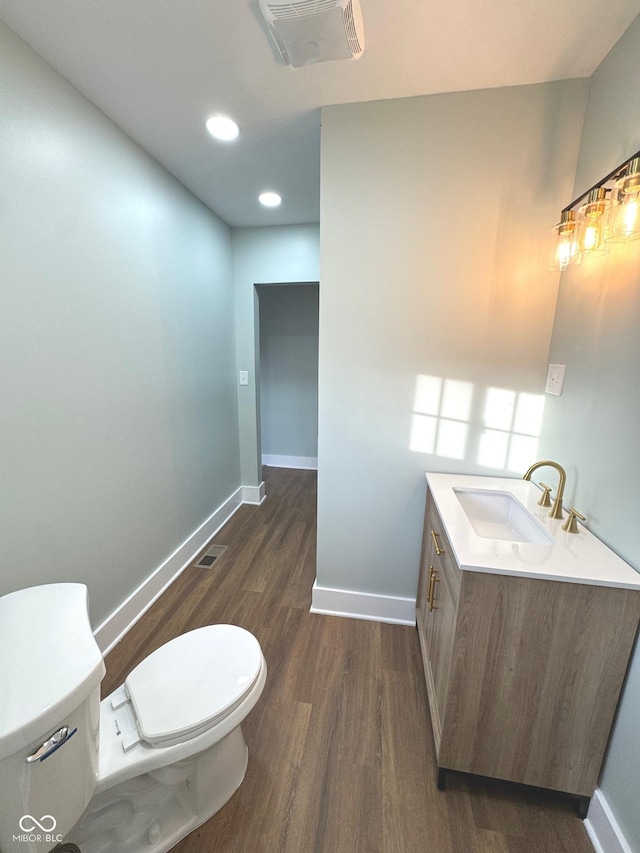 bathroom featuring hardwood / wood-style floors, vanity, and toilet