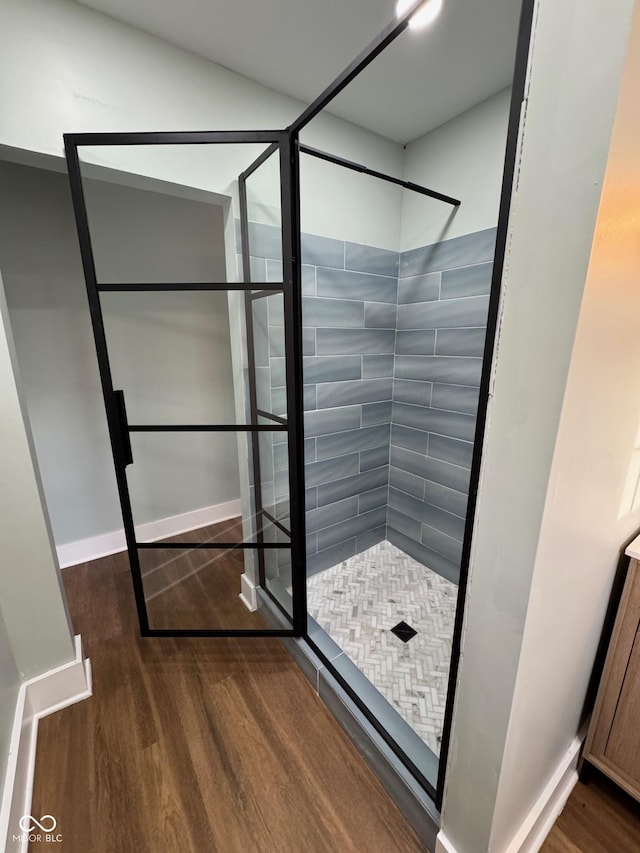 bathroom with a shower and wood-type flooring