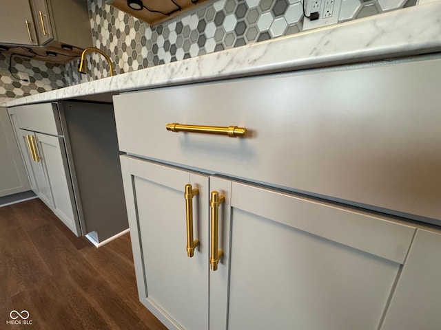 room details with decorative backsplash and dark hardwood / wood-style flooring