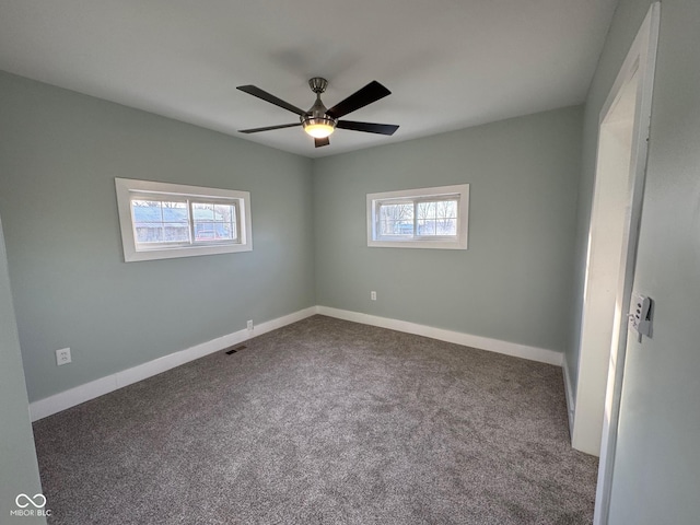 carpeted spare room featuring ceiling fan