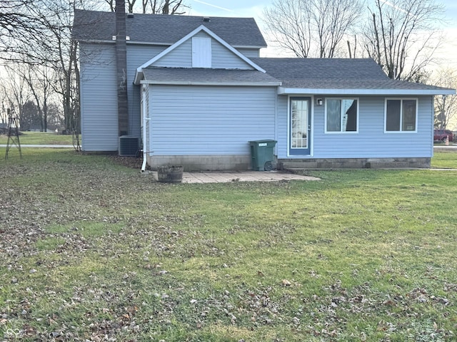 view of front of home featuring central air condition unit, a patio, and a front yard