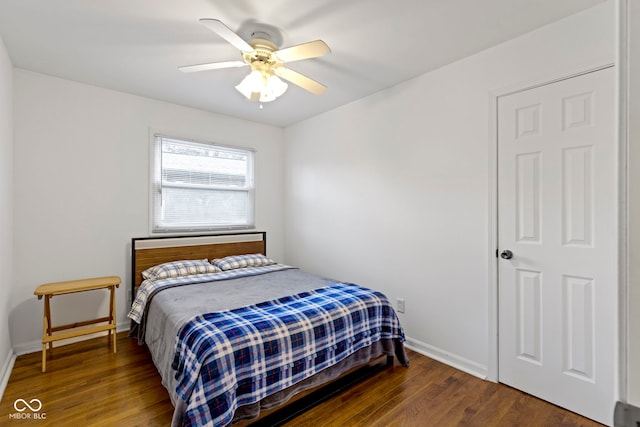 bedroom with dark hardwood / wood-style floors and ceiling fan