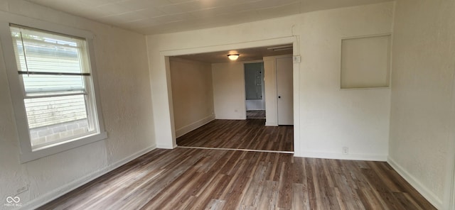 unfurnished room featuring dark hardwood / wood-style flooring