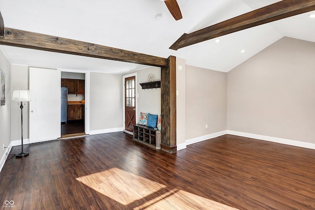 unfurnished living room featuring ceiling fan, dark hardwood / wood-style flooring, and vaulted ceiling with beams