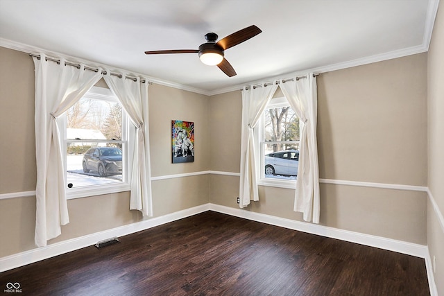 empty room with ceiling fan, hardwood / wood-style floors, ornamental molding, and plenty of natural light