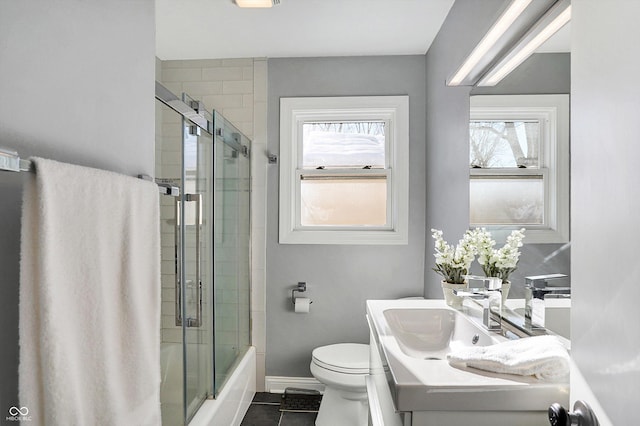 full bathroom with toilet, shower / bath combination with glass door, tile patterned floors, and vanity