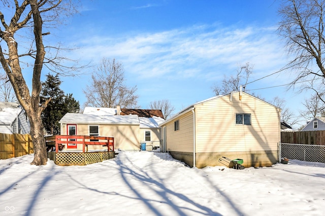 snow covered property with a wooden deck