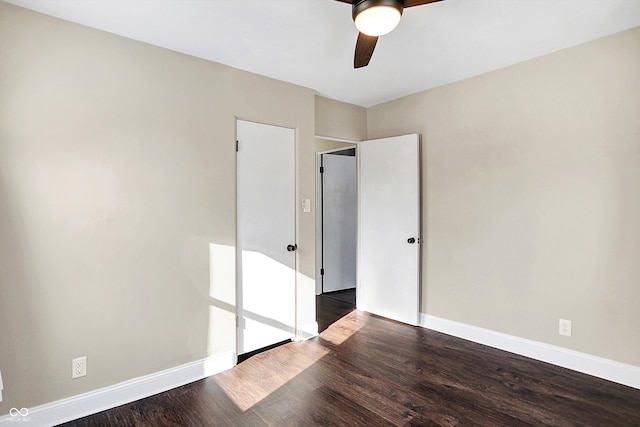 unfurnished bedroom featuring ceiling fan and dark hardwood / wood-style flooring