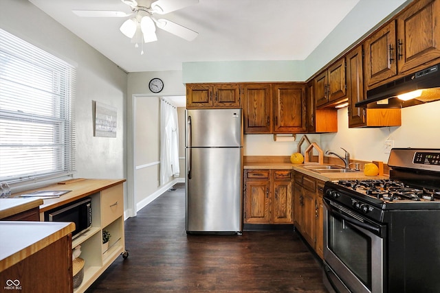 kitchen featuring appliances with stainless steel finishes, ceiling fan, dark hardwood / wood-style floors, and sink