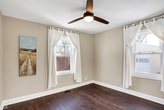 empty room featuring hardwood / wood-style floors and ceiling fan