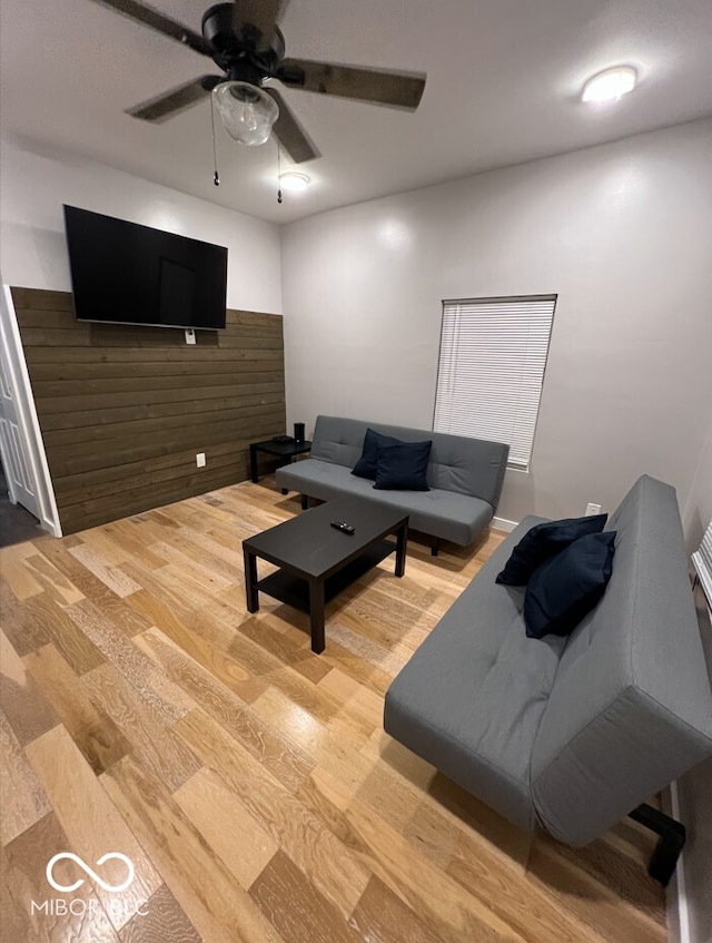 living room with hardwood / wood-style floors and ceiling fan