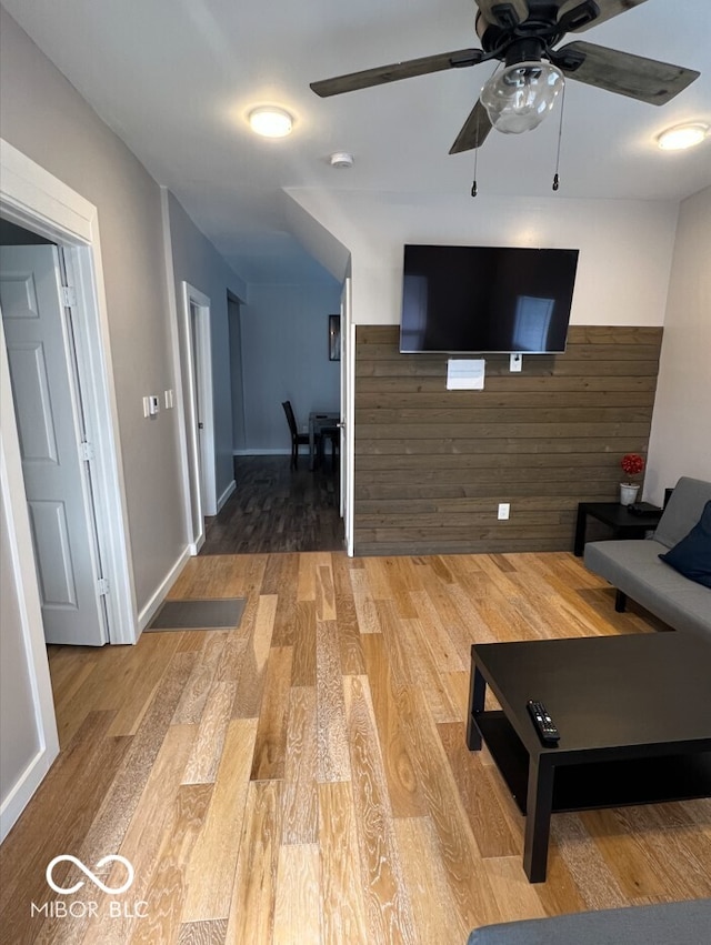 unfurnished living room featuring hardwood / wood-style flooring and ceiling fan