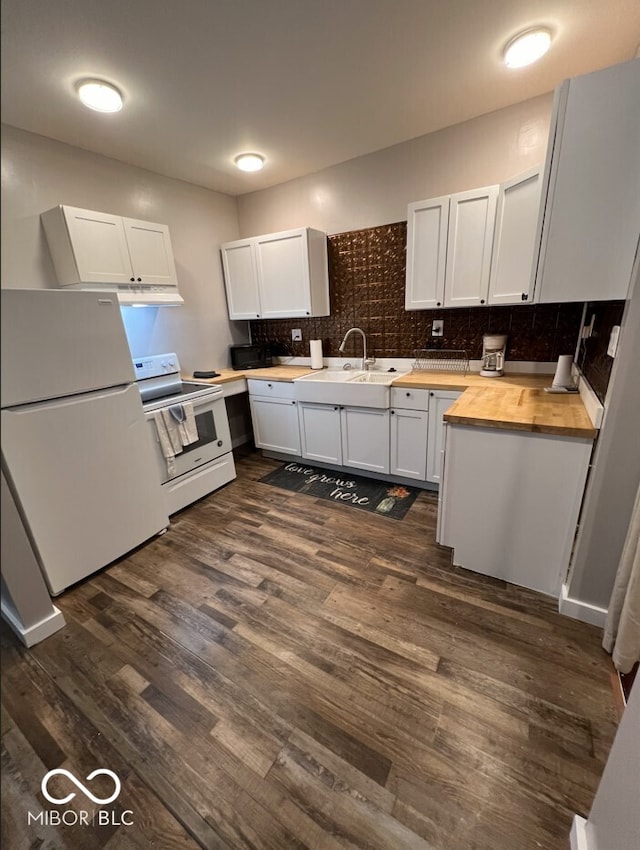 kitchen with white appliances, sink, dark hardwood / wood-style floors, white cabinetry, and butcher block counters