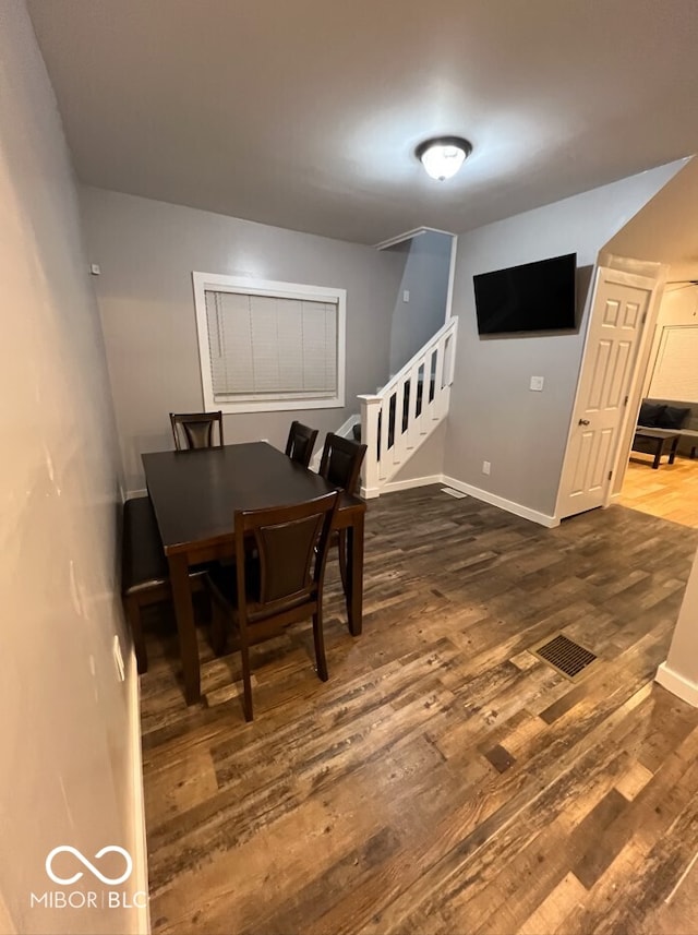 dining room with dark hardwood / wood-style flooring