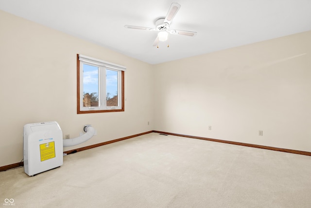 spare room featuring ceiling fan and light colored carpet