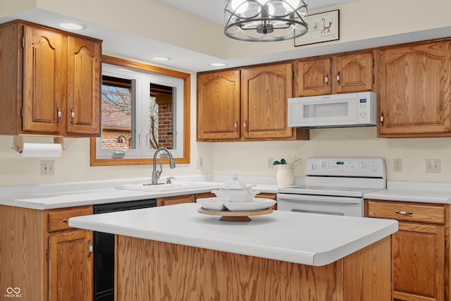 kitchen with sink, black dishwasher, an inviting chandelier, a kitchen island, and range