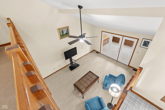 unfurnished living room featuring light carpet, high vaulted ceiling, and ceiling fan