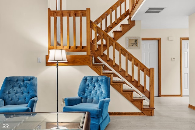 stairs featuring hardwood / wood-style floors