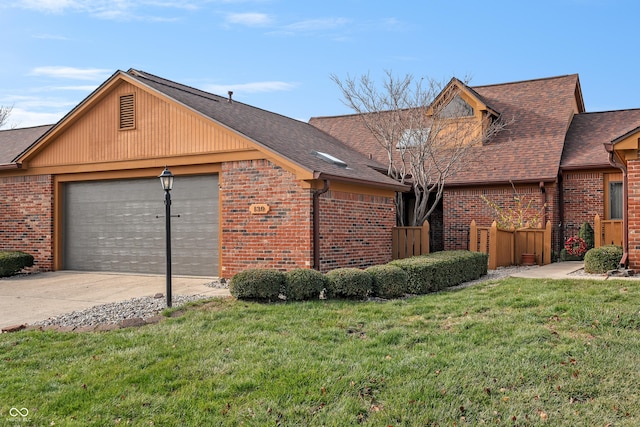 view of front of property featuring a garage and a front lawn