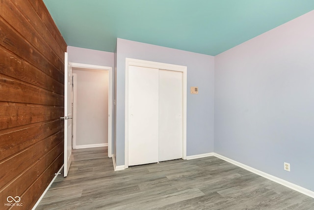 unfurnished bedroom featuring wood-type flooring and a closet