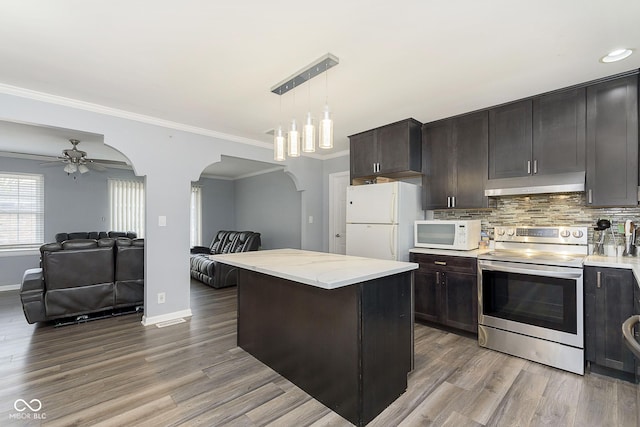 kitchen with dark brown cabinetry, white appliances, decorative light fixtures, and hardwood / wood-style flooring