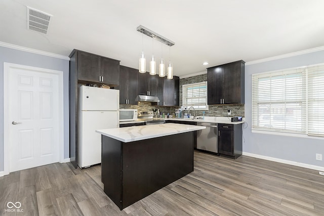 kitchen with a center island, stainless steel appliances, light hardwood / wood-style flooring, and hanging light fixtures