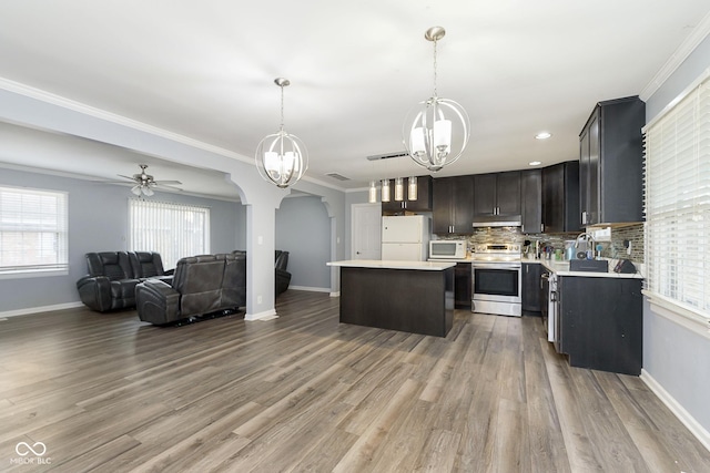 kitchen with pendant lighting, white appliances, crown molding, hardwood / wood-style flooring, and a kitchen island