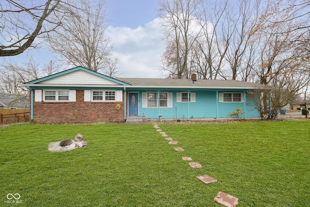 single story home featuring a front lawn and an outdoor fire pit